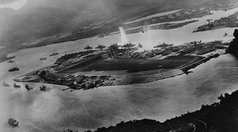 Photograph taken from a Japanese plane during the torpedo attack on ships moored on both sides of Ford Island shortly after the beginning of the Pearl Harbor attack. U.S. Navy photograph, Wikipedia Commons.