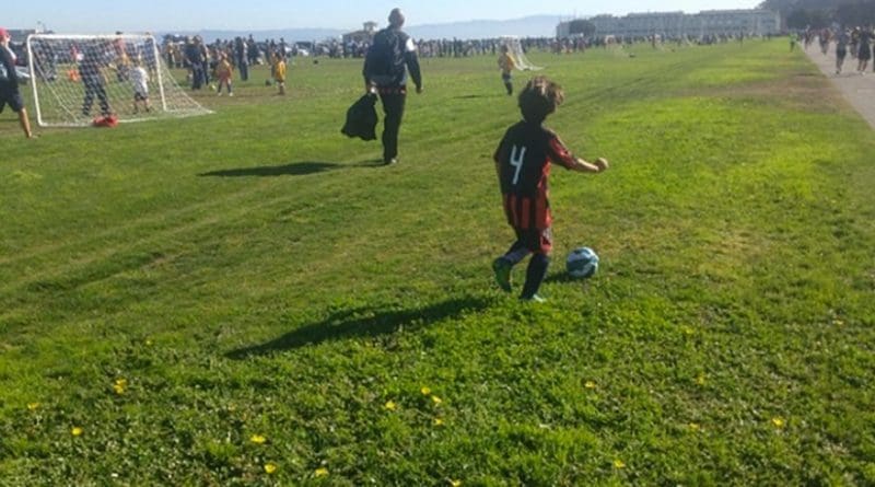 Child playing soccer.