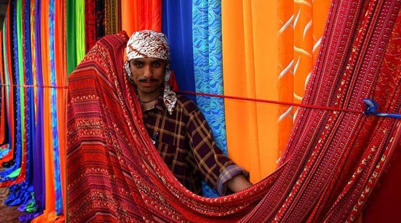 Sunday textile market on the sidewalks of Karachi, Pakistan. Photo by Steve Evans, Wikimedia Commons.