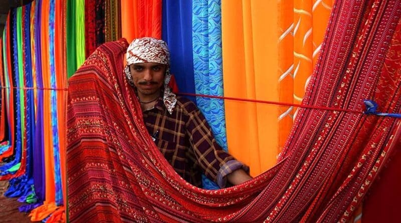 Sunday textile market on the sidewalks of Karachi, Pakistan. Photo by Steve Evans, Wikimedia Commons.