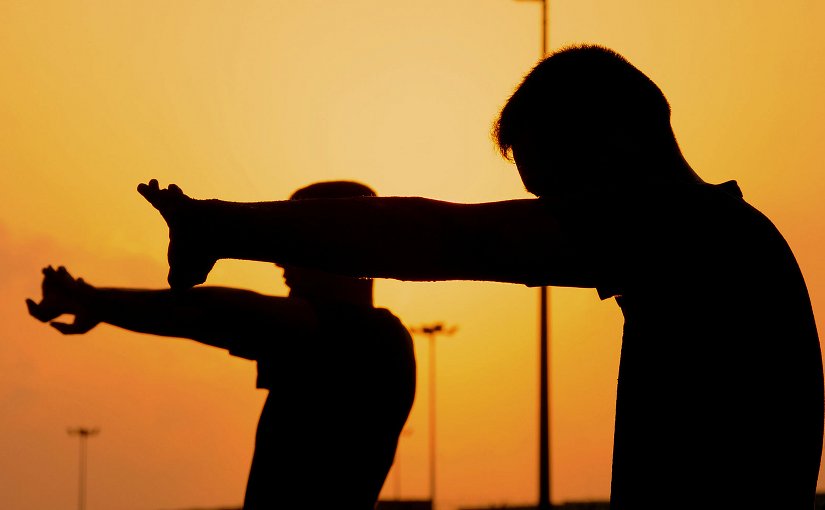 Members of the U.S. Marines 9th Provisional Security Forces, from Combined Joint Task Force-Horn of Africa stretch early in the morning after finishing Physical Training, on the last day of a Corporals Course here on Camp Lemonier, Djibouti. Photo by Staff Sgt. Joseph Swafford, Wikimedia Commons.