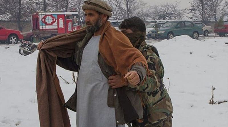 An Afghan soldier searches people receiving supplies in Afghanistan’s Parwan province during a humanitarian aid mission, Jan. 28, 2017. Army photo by Sgt. 1st Class Eliodoro Molina