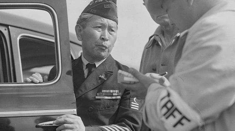 Dressed in uniform marking service in World War I, this veteran enters Santa Anita assembly center for persons of Japanese ancestry evacuated from West Coast, April 5, 1942, Arcadia, California (National Archives and Records Administration/Clem Albers)