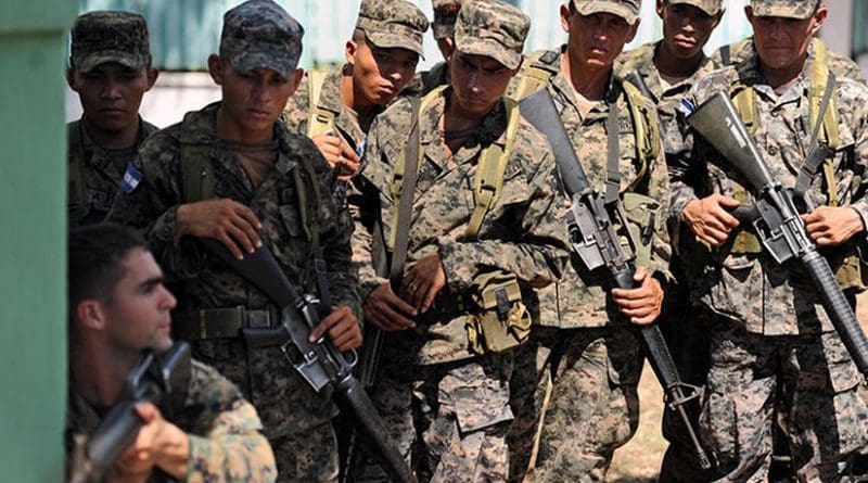 U.S. Marine Staff Sgt. Daniel Monteiro, lower left, assigned to Marine Corps Training and Advisory Group, demonstrates proper tactical movement to soldiers assigned to 11th Honduran Army Battalion. U.S. Navy photo by Mass Communication Specialist 2nd Class Ricardo J. Reyes, Wikimedia Commons.