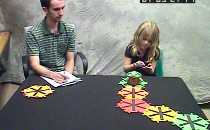 A 6-year-old girl follows instructions on a smartphone to program a turtle robot. Credit UW Institute for Learning & Brain Sciences