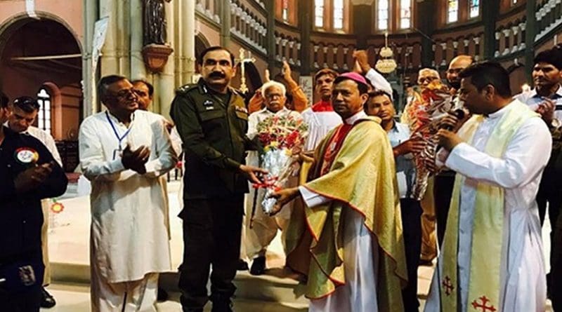 Archbishop Sebastian Francis Shah of Lahore presents security forces with bouquets at the Easter vigil Mass on April 16 to thank them after they foiled a terrorist attack. Photo Credit: ucanews.com