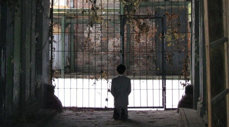HIM, a statue by Maurizio Cattelan, depicting Hitler kneeling in prayer in a courtyard in the former Warsaw Ghetto. Photo by Maciej Szczepańczyk, Wikimedia Commons.