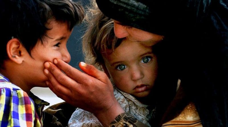 An Iraqi mother comforts her children. Photo by Russell l. Klika, SSG, DoD, Wikipedia Commons.