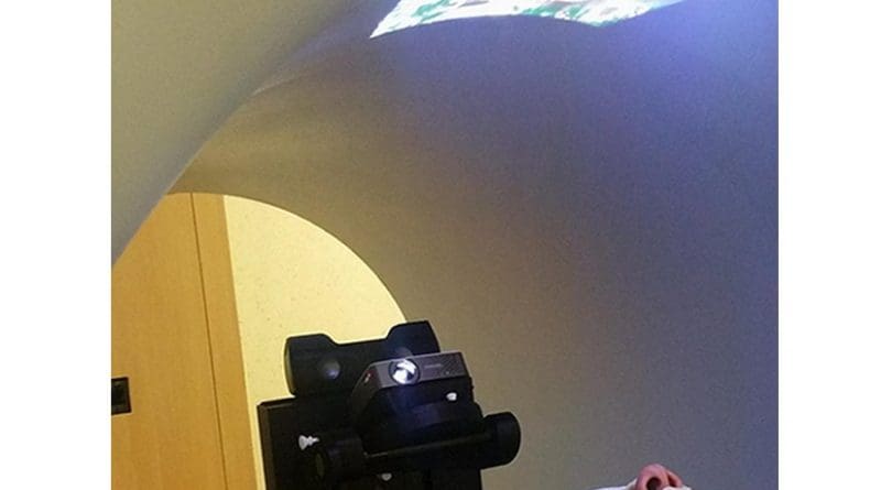 A child watches a movie while undergoing radiotherapy treatment. Credit VLADI project