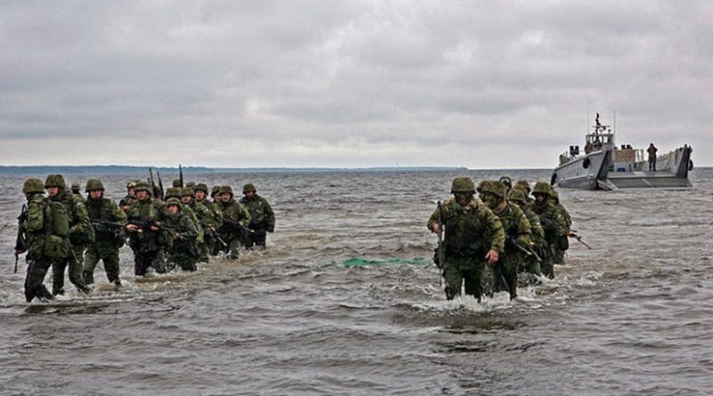 Estonian soldiers wade ashore during a combined U.S. and Estonia amphibious assault training exercise during Baltic Operations (BALTOPS) 2010. U.S. Marine Corps photo by Sgt. Rocco DeFilippis.