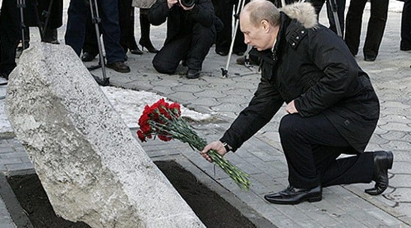 President of Russia Vladimir Putin lays flowers, on 1 February 2008, at the memorial to the victims of the Novocherkassk massacre. Photo Credit: Kremlin.ru, Wikipedia Commons.