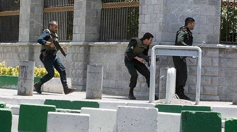 Iranian Security guard behind the parliament building during terrorist attack by Islamic State. Photo by Tasnim News Agency, Wikipedia Commons.