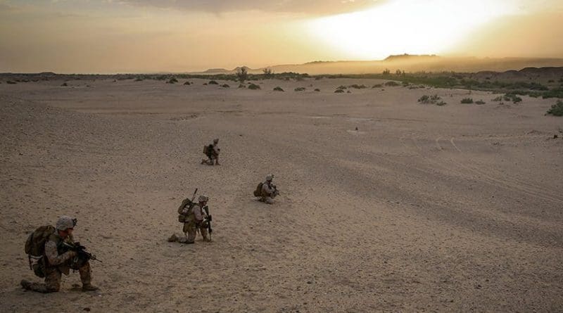 Marines with Bravo Company, 1st Battalion, 7th Marine Regiment, provide outboard security after offloading from CH-53E Super Stallion helicopter during mission in Helmand Province, May 1, 2014 (U.S. Marine Corps/Joseph Scanlan)
