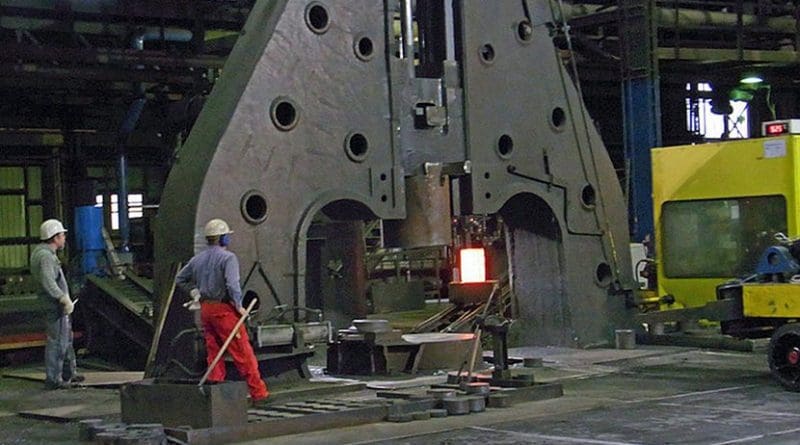 Hot metal ingot being loaded into a hammer forge. Photo by Rainer Halama, Wikipedia Commons.