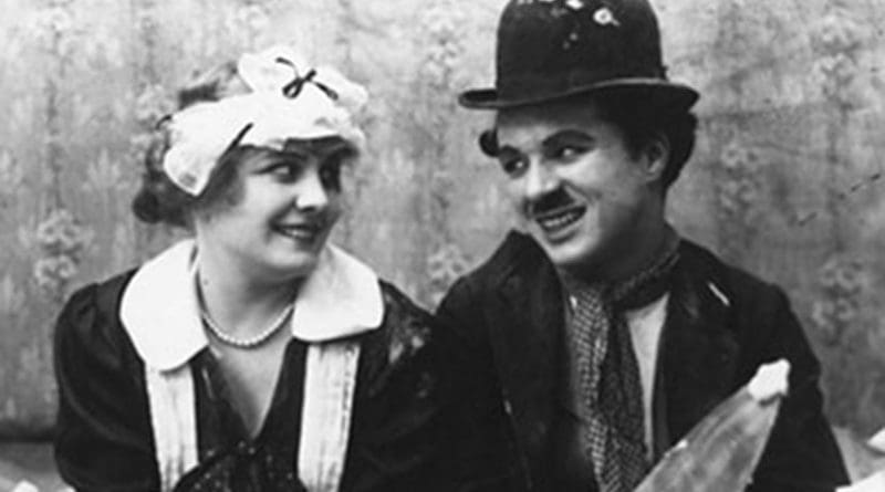 Still of Charlie Chaplin and Edna Purviance in the 1915 film Work.