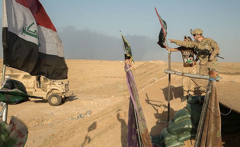 A U.S. soldier of the 101st Airborne Division and a member of the Iraqi Special Operations Forces discuss assessment of Iraqi security force checkpoints. U.S. Army photo by Spc. Christopher Brecht, Wikipedia Commons.