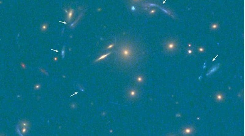 The multiple images of the discovered galaxy are indicated by white arrows (bottom right shows the scale of the image in seconds of arc). Credit Hubble Space Telescope (HST)