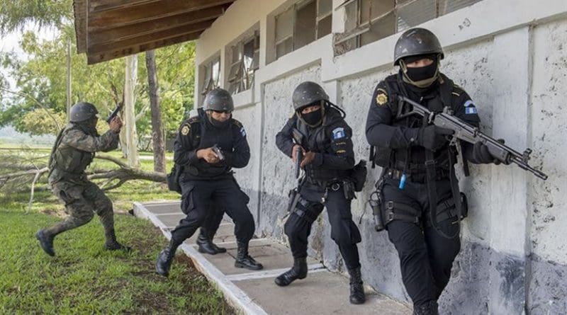 Police and soldiers in Guatemala prepare to enter a building during a U.S. Army-supported evaluation exercise to train the Guatemalan forces to be better prepared to combat illegal drug trafficking operations, Jupiata, Guatemala. Air Force photo by Tech. Sgt. Trevor Tiernan