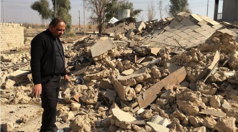 A Catholic church ruined by ISIS in Karamdes, Iraq, is examined by a priest following the predominately Christian town's liberation. Photo Credit: Knights of Columbus.