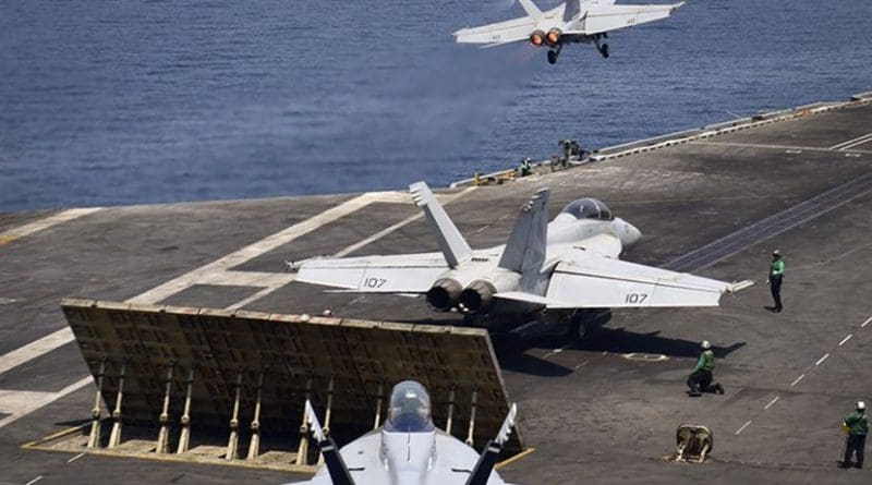 n F/A-18F Super Hornet from the "Black Knights" of Strike Fighter Squadron (VFA) 154 launches from the flight deck of the aircraft carrier USS Nimitz (CVN 68) while another Super Hornet from the "Black Knights" and an EA-18G Growler from the "Gray Wolves" of Electronic Attack Squadron (VAQ) 142 prepare to launch, July 29, 2017, in the Arabian Gulf. Nimitz is deployed in the U.S. 5th Fleet area of operations in support of Operation Inherent Resolve. While in this region, the ship and strike group are conducting maritime security operations to reassure allies and partners, preserve freedom of navigation, and maintain the free flow of commerce. (U.S. Navy photo by Mass Communication Specialist 3rd Class Weston A. Mohr/Released)