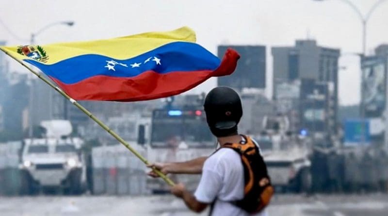 Protester facing the Venezuelan National Guard during a protest. Photo by Efecto Eco, Wikipedia Commons.