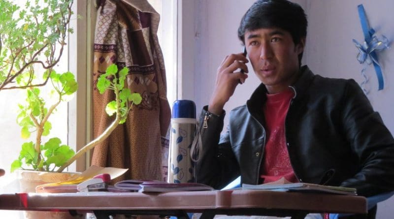 Ghulam at his study desk in Kabul, calling to make sure his family members were well, in the minutes following a bomb blast nearby