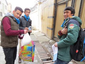 Ghulam ( extreme right ) with Hussein and Sarwar going house to house to collect food donations for the Food Bank