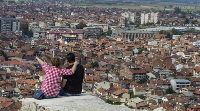 Couple sits above Prizen, Kosovo.
