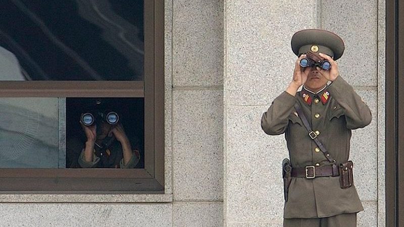 Soldiers from the North Korean People's Army look south while on duty in the Joint Security Area. Photo by Edward N. Johnson, US Military, Wikipedia Commons.