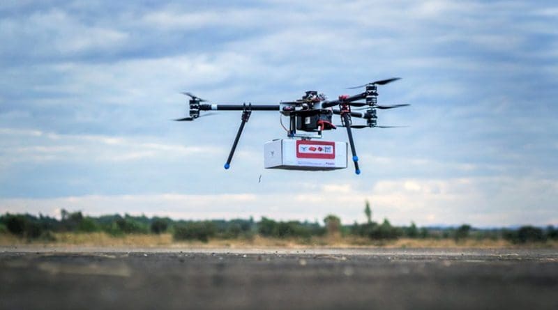 UNICEF Innovation team tests an unmanned aerial vehicle (UAV), also known as a drone, carrying a cargo payload box, which can potentially carry humanitarian supplies at Kasungu Aerodrome in central Malawi. Photo: UNICEF/UN070227/Chim Chisiza