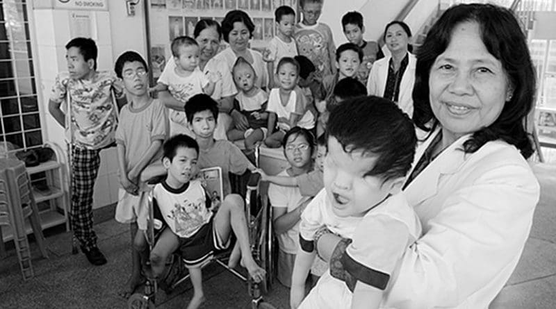 Ho Chi Minh. Professor Nguyen Thi Ngoc Phuong, at Tu Du Obstetrics and Gynecology Hospital is pictured with a group of handicapped children, most of them victims of Agent Orange. Photo by Alexis Duclos, Wikipedia Commons.