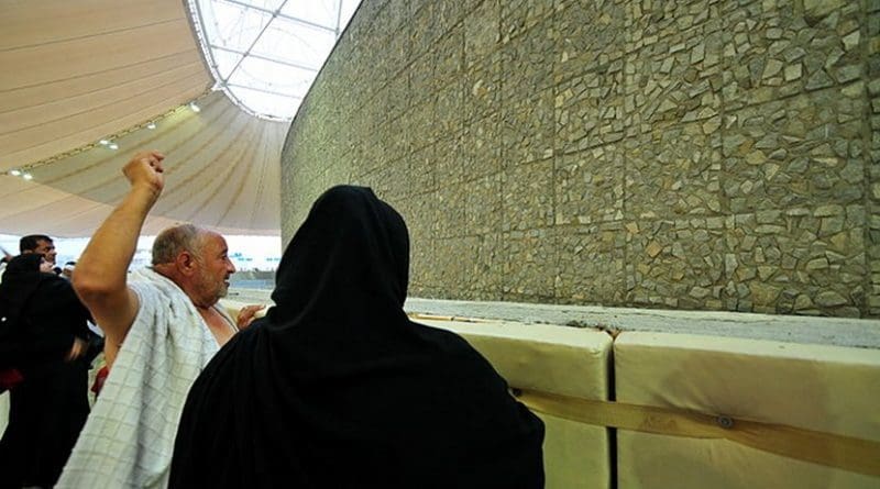A man stones the Devil at the Mecca, Saudi Arabia. The ritual is a symbolic rite in which pebbles are thrown at pillars that represent the temptations of Satan. Photo by Fadi El Binni of Al Jazeera English, Wikipedia Commons.