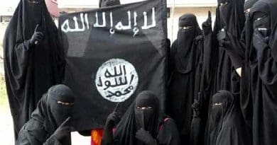 Women holding Islamic State flag.
