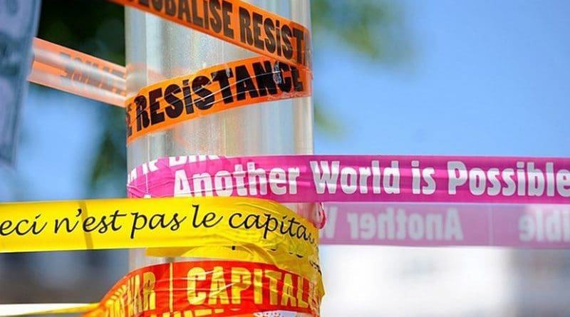 Anti-capitalism and anti-globalization banners. Photo by Guillaume Paumier, Wikimedia Commons.