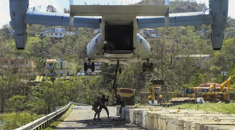 Marines attach a barrier to a V-22 Osprey tilt-rotor aircraft while working to reinforce the Guajataca Dam in Puerto Rico in Hurricane Maria’s aftermath, Oct. 3, 2017. Army photo by Pfc. Deomontez Duncan