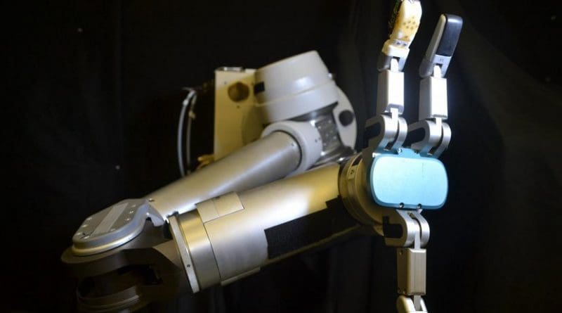 The flexible sensor skin wrapped around the robot finger (orange) is the first to measure shear forces with similar sensitivity as a human hand -- which is critical for successfully gripping and manipulating objects. Credit UCLA Engineering