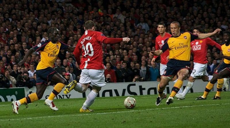 Wayne Rooney and Mikael Silvestre compete for the ball during the UEFA Champions League 2008-09 semi-final first leg. Photo by Gordon Flood, Wikimedia Commons.