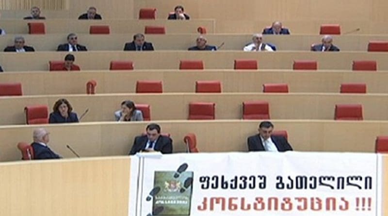 Lawmakers from the European Georgian displayed a banner in the parliament chamber reading “Trampled Down Constitution.” Photo: screenshot.