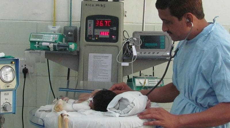 Professor Sangappa Dhaded attending to an infant in the Neonatal Intensive care Unit.