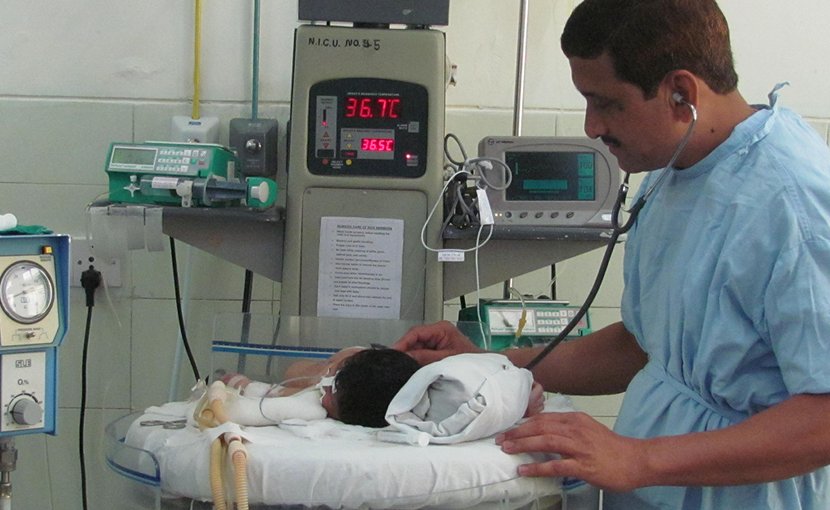 Professor Sangappa Dhaded attending to an infant in the Neonatal Intensive care Unit.