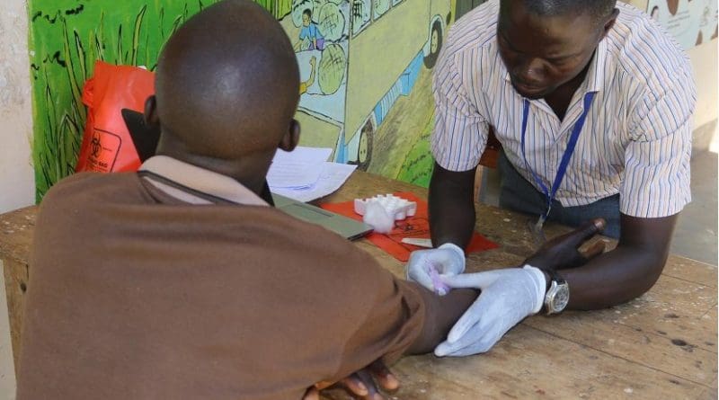 A research assistant draws blood for HIV testing from a participant in the Rakai Community Cohort Study. Credit Rakai Health Sciences Program