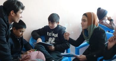 Mursal interacts with her teacher Naser during a Friday afternoon Bridge class, encouraging Street Kid School soon-to-be-graduates to volunteer at the Borderfree Centre. Photo credit: Carolyn Coe