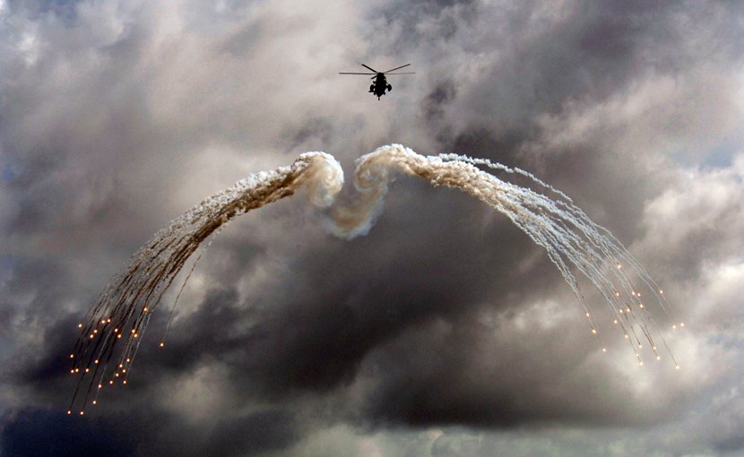 A Canadian CH 124 Sea King helicopter from HMCS Ville de Québec (VDQ) fires off defensive flares during an exercise above the Indian Ocean. Photo by MCpl Kevin Paul, Canadian Forces Combat Camera.