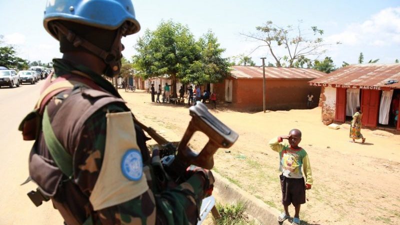 A Congolese child saluting a UN peacekeeper. Photo MONUSCO/Abel Kavanagh, Wikipedia Commons.