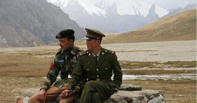 Chinese and Pakistan border guards at Khunjerab Pass. Photo by Anthony Maw, Wikimedia Commons.