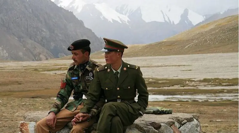 Chinese and Pakistan border guards at Khunjerab Pass. Photo by Anthony Maw, Wikimedia Commons.