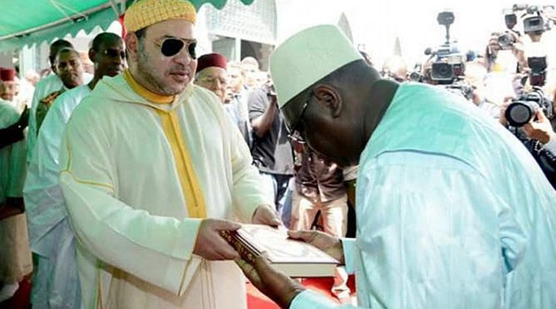 Morocco's King Mohammed VI offering the Holy Koran to the faithful during his June 2015 visit to Africa - religious diplomacy at work.