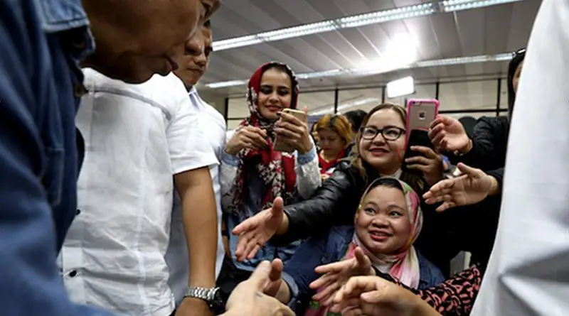 President Rodrigo Duterte greets Filipino migrant workers returning from the Middle East in February. (Photo courtesy of the Presidential Communications Office)