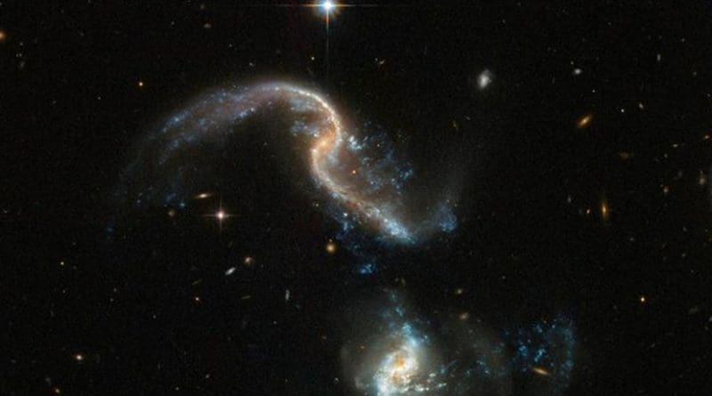 Arp 256 is a stunning system of two spiral galaxies, about 350 million light-years away, in an early stage of merging. The image, taken with the NASA/ESA Hubble Space Telescope, displays two galaxies with strongly distorted shapes and an astonishing number of blue knots of star formation that look like exploding fireworks. The star formation was triggered by the close interaction between the two galaxies. Credit ESA/Hubble, NASA