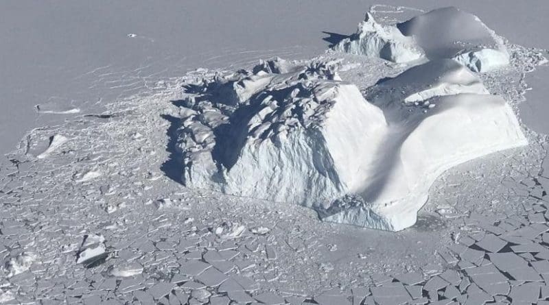 A large iceberg floating among sea ice floes, as seen during an operation IceBridge survey flight on Apr. 21, 2018. Credits: NASA/Linette Boisvert Credit Credits: NASA/Linette Boisvert